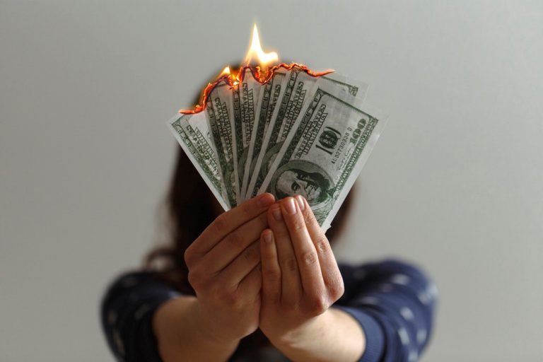 A woman burning money